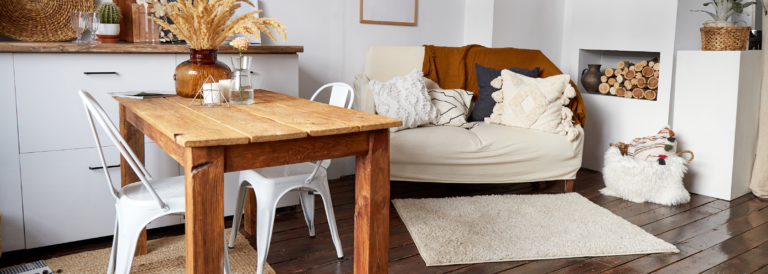 Modernes, minimalistisches Interieur im Öko-Stil. Eine natürliche, helle Wohnung im trendigen Stil. Dekorative Strohlampe. Holzboden und Holztisch.